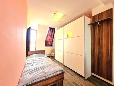 a small bedroom with a bed and a closet at Sea Star Studio-to the Sea Garden in Burgas City