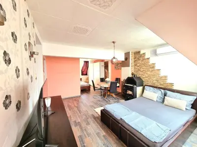 a bedroom with a bed and a brick wall at Sea Star Studio-to the Sea Garden in Burgas City