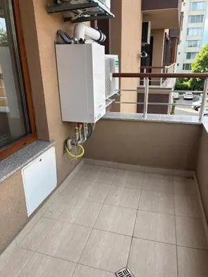 a balcony with an air conditioner on a building at Дизайнерски апартамент in Burgas City