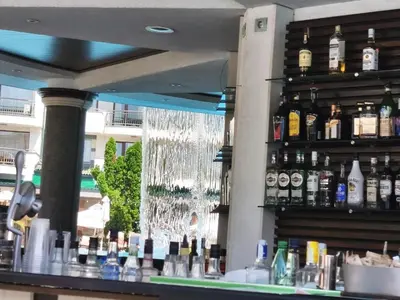 a bar with lots of bottles of alcohol at Emerald Apartman Wellness & Spa in Ravda