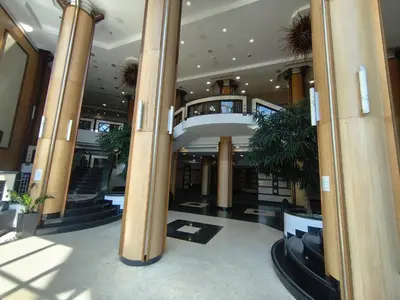 a large lobby with columns in a building at Emerald Apartman Wellness & Spa in Ravda