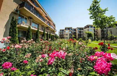 a garden of flowers in front of a building at Studio near the center in Sunny Beach