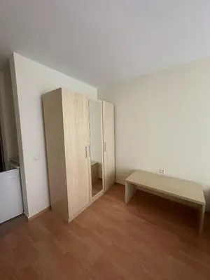 an empty room with a bench and a cabinet at Studio near the center in Sunny Beach