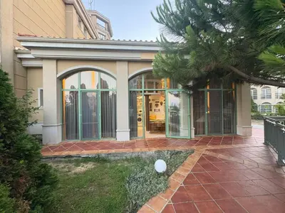 a house with glass doors and a palm tree at Flores Gardan ART Studio in Chernomorets