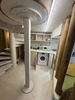 a kitchen with a washing machine in a room at Flores Gardan ART Studio in Chernomorets