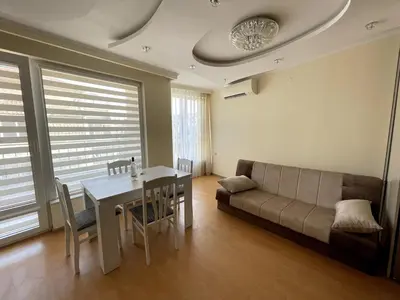 a living room with a couch and a table at 2BR Garden Bay Apartment in Varna City