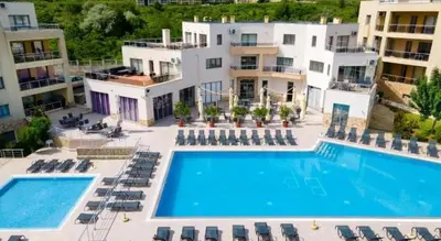 an aerial view of a hotel with a swimming pool at The white flat in Byala