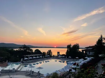 a view of a pool at a resort at sunset at Cozy Ground-Floor Apartment with Terrace in Sozopol