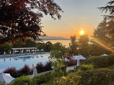 a view of a pool with the sunset in the background at Cozy Ground-Floor Apartment with Terrace in Sozopol