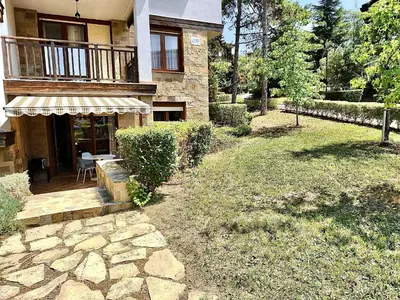 a house with a balcony and a patio at Cozy Ground-Floor Apartment with Terrace in Sozopol