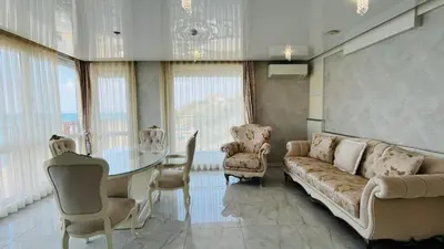 a living room with a couch and a table and chairs at PARADADISO B 307 Two Bedroom Sea View Apartment in Nesebar