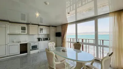 a kitchen with a table and a large window at PARADADISO B 307 Two Bedroom Sea View Apartment in Nesebar