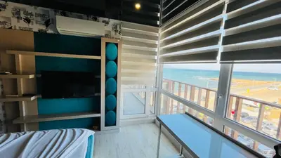 a bedroom with a view of the ocean from a balcony at PARADADISO B 307 Two Bedroom Sea View Apartment in Nesebar