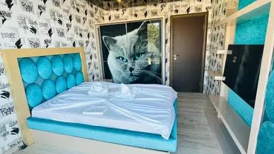 a room with a bed with a picture of a cat at PARADADISO B 307 Two Bedroom Sea View Apartment in Nesebar