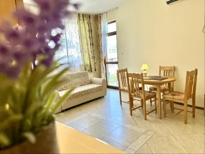 a living room with a couch and a table and chairs at Sunny Sea - Menada Apartments in Sunny Beach