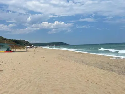 a sandy beach with a tent and the ocean at Палатка на Кара Дере in Byala