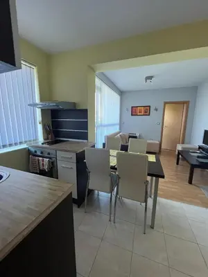 a kitchen and dining room with a table and chairs at Private 2-Bedroom Apartment with Pool and Free Parking in Marina Holiday Club Pomorie in Pomorie