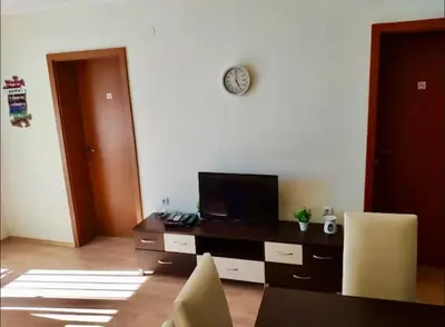 a room with a desk with a tv and chairs at Two bedroom Apartment in Fort Noks Panorama beach in Elenite