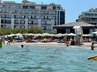 a group of people in the water at a beach at Sunrise Apartment in Pomorie