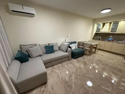 a living room with a couch and a table at Sunrise Apartment in Pomorie