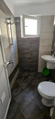a bathroom with a toilet and a sink at Библиотеката in Pomorie