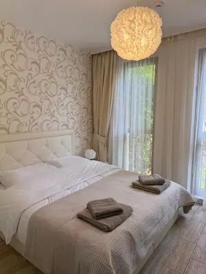 a bedroom with a large bed with two towels on it at Boho apartament Cascadas family in Sunny Beach