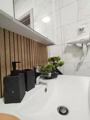 a bathroom with a sink with two plants on it at Sea Breeze in Burgas City