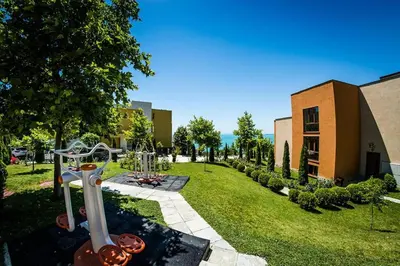 a garden with a playground and a building at Imperial Sea View in Burgas City