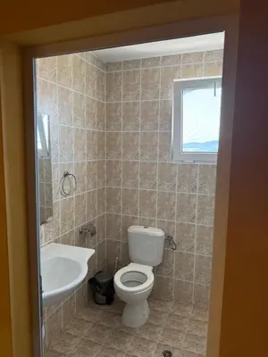 a bathroom with a toilet and a sink at Хотел Модева in Chernomorets