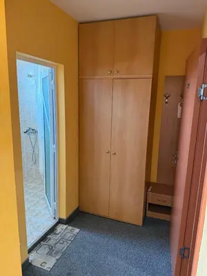 a bathroom with a shower and a wooden cabinet at Хотел Модева in Chernomorets