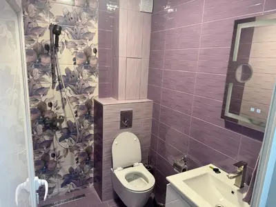 a small bathroom with a toilet and a sink at Апартамент Велкови in Tsarevo