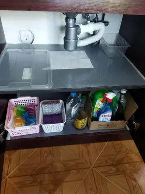 a shelf under a kitchen sink with food at Святая Елена in Sunny Beach