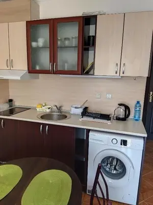 a kitchen with a washing machine and a sink at Святая Елена in Sunny Beach