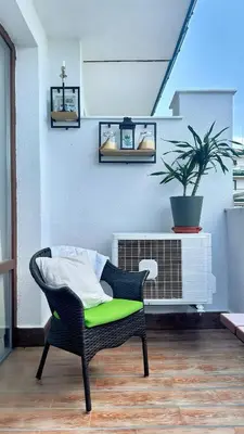 a chair with a green cushion in a living room at Emerald Breeze Studio in Hotel SPA Resort Emerald in Ravda