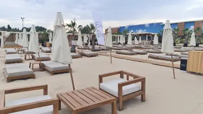 a group of lounge chairs and umbrellas on a beach at Apartment 16 - Rainbow Holiday Complex in Sunny Beach