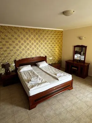 a bedroom with a large bed and a mirror at Sea View Apartment Sveti Vlas in Sveti Vlas