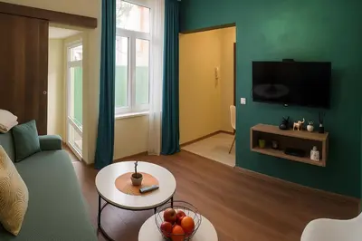 a living room with a couch and a tv at KOKO House in Varna City