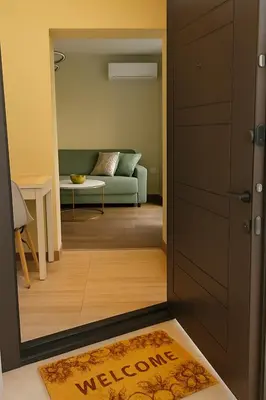 a door leading to a living room with a couch at KOKO House in Varna City