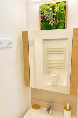a bathroom with a mirror and a sink at KOKO House in Varna City