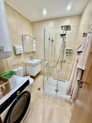 a bathroom with a shower and a toilet and a sink at Beach Please Apartment in Burgas City