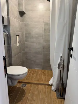 a bathroom with a toilet and a shower at Апартаменти в Созопол, Каваци- Север in Sozopol