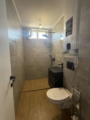 a bathroom with a toilet and a sink at Апартаменти в Созопол, Каваци- Север in Sozopol