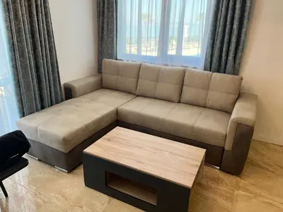 a living room with a couch and a coffee table at Onyx Sveti Vlas частни апартаменти in Sveti Vlas