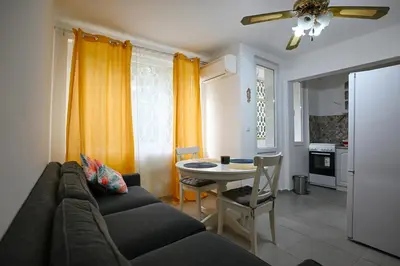 a living room with a couch and a table at Уют и тишина на топ локация in Varna City