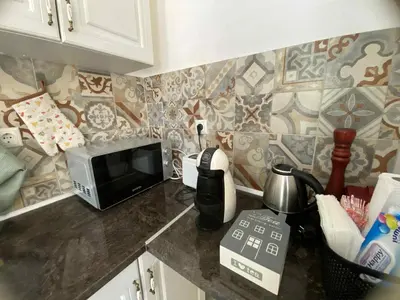 a kitchen with a counter top with a microwave at Уют и тишина на топ локация in Varna City