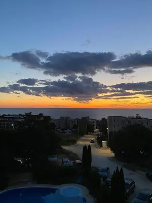 a sunset from the balcony of a building at Sea View Apartment in Byala in Byala