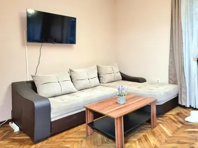 a living room with a couch and a table at Nicky's Apartment - with Private Parking in Center in Burgas City