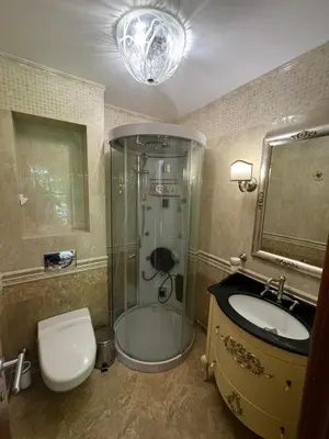 a bathroom with a shower and a toilet and a sink at Апартамент в Лозенец, Oasis Resort and Spa in Lozenets