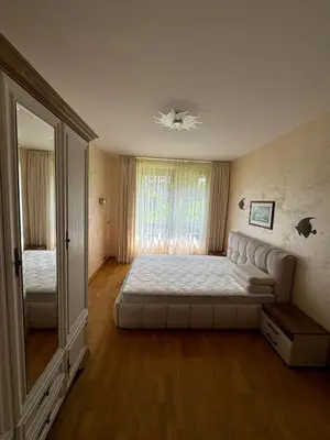 a bedroom with a large bed and a large mirror at Апартамент в Лозенец, Oasis Resort and Spa in Lozenets