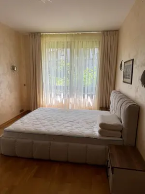 a large bed in a room with a window at Апартамент в Лозенец, Oasis Resort and Spa in Lozenets
